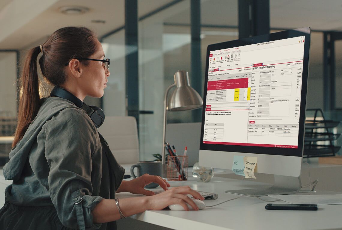 A woman works on a feasibility analysis on the computer.