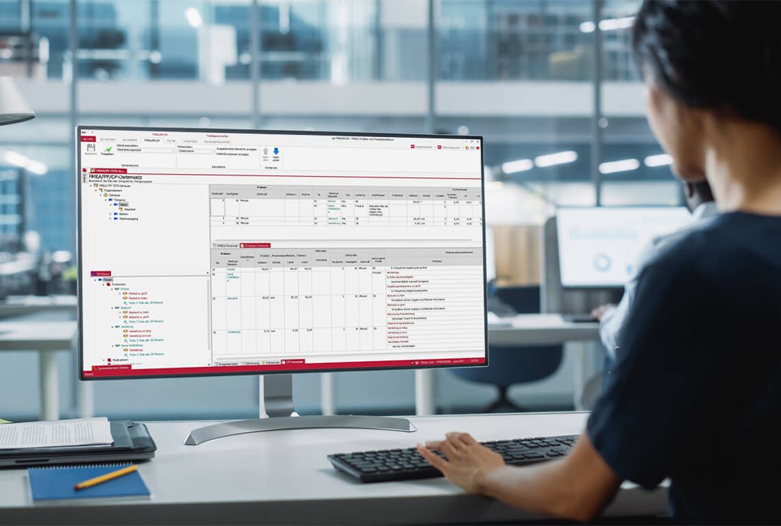 A woman creates a production control plan on the computer.