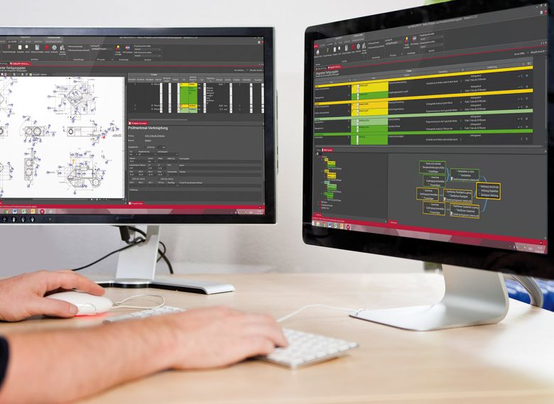 Man sits at a desk in front of two screens and works on an FMEA