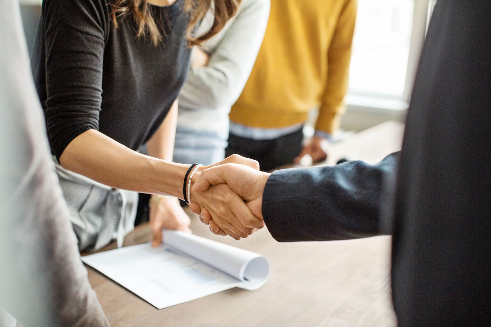 Two people shake hands